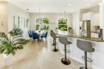 Waterfall peninsula hosts four counter stools -sit added guests-